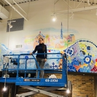 Lia Ali paints one of  the largest murals in the history  of Long Island Photo