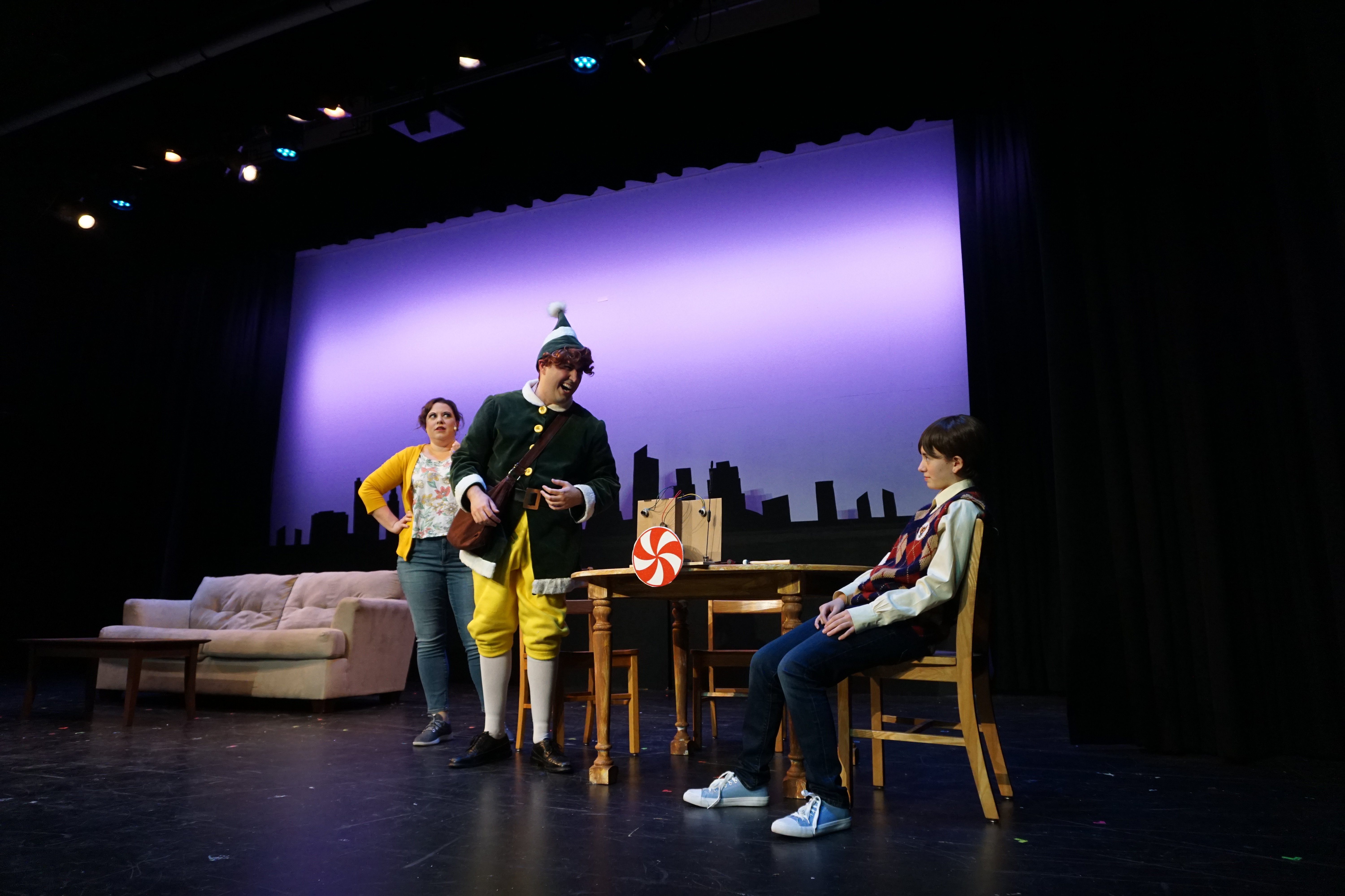 Amanda Walsh as Emily Hobbs, Jesse Thielsen as Buddy the Elf, and Danica Pavic as Michael Hobbs