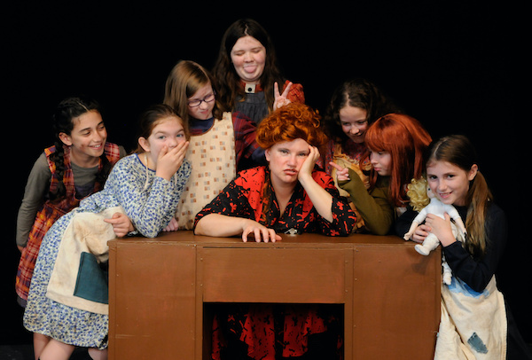 Eve-Marie Webster (center) as Miss Hannigan, with 
