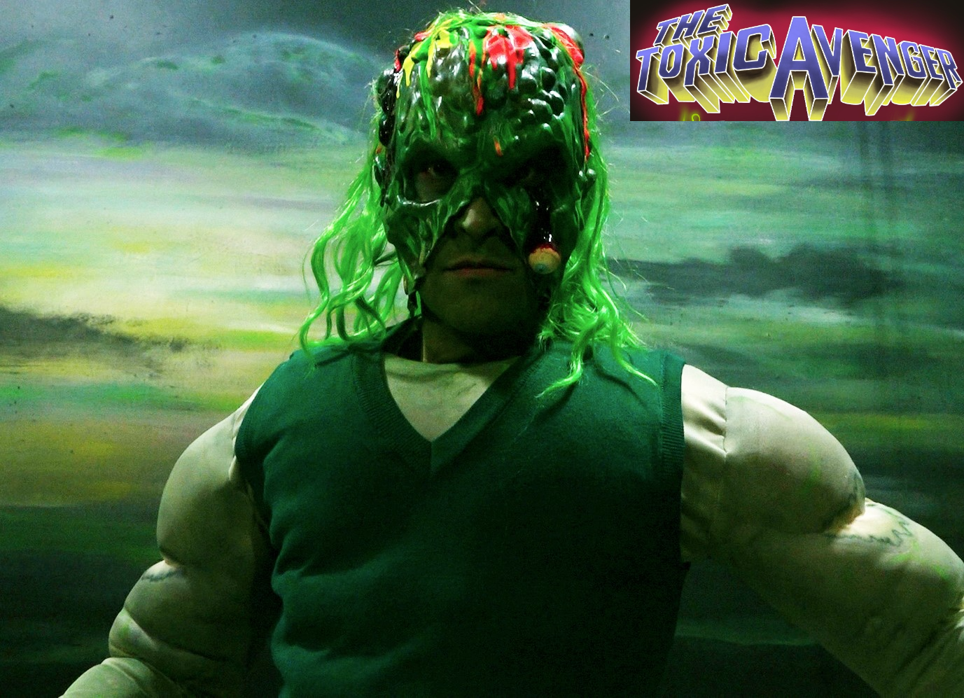 Promo photo of The Toxic Avenger with Logo
