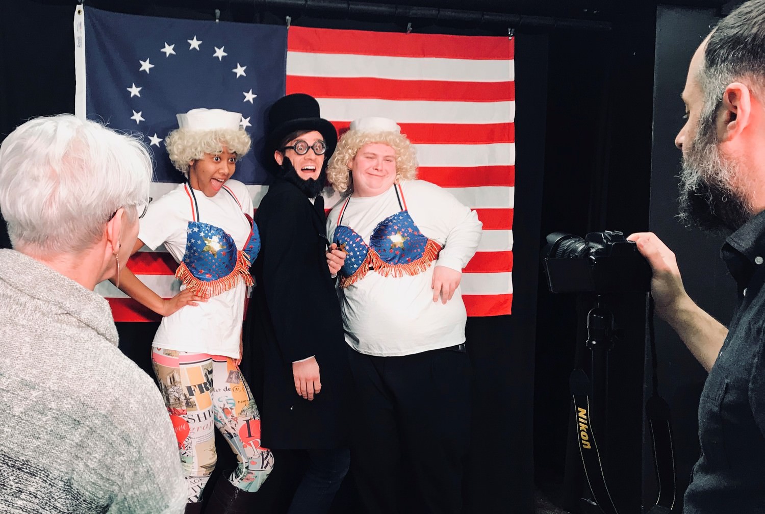 Costume Designer, Melinda Pacha, and Resident Photographer and Ticket Office Coordinator, Evans Tasiopoulos, direct the cast of The Complete History of America (abridged) to pose during the publicity shoot. 