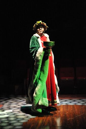 Do Not Make Me Come Up There And Get You!: Darryl Maximilian Robinson as The Ghost of Christmas Present summons Scrooge in the 2010 Glendale Centre Theatre musical staging of A Christmas Carol.