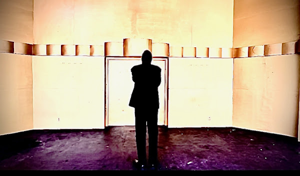 Pondering Poe: Veteran stage actor and play director Darryl Maximilian Robinson considers his choices upon the outdoor stage of Levitt Pavilion in LA's MacArthur Park for the video shoot of Edgar Allan Poe's 'The Conqueror Worm'. Photo by Danny Belrose.