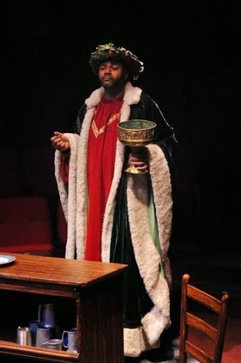 Cratchit Watching: Darryl Maximilian Robinson as The Ghost of Christmas Present observes the holiday activities of The Cratchit Family in the 2010 Glendale Centre Theatre A Christmas Carol.