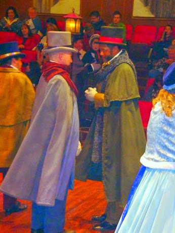 Carolers Confer: New York stage-trained actor Shawn Cahill as A Caroler and Chicago stage-trained actor Darryl Maximilian Robinson as A Caroler in the 2010 Glendale Centre Theatre A Christmas Carol.