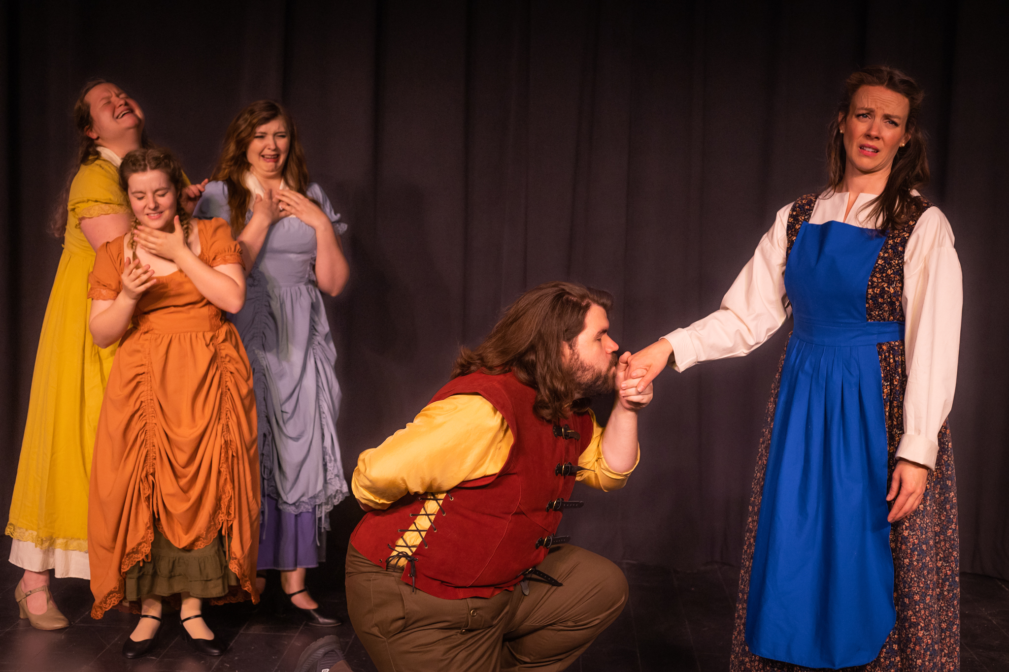 Gaston (Spencer Pilcher) romances Belle (Rebekah Raze) to the dismay of Les Filles la Ville (L to r: Brianna Lau, Sarah Vaughan, Stephanie Blakely)