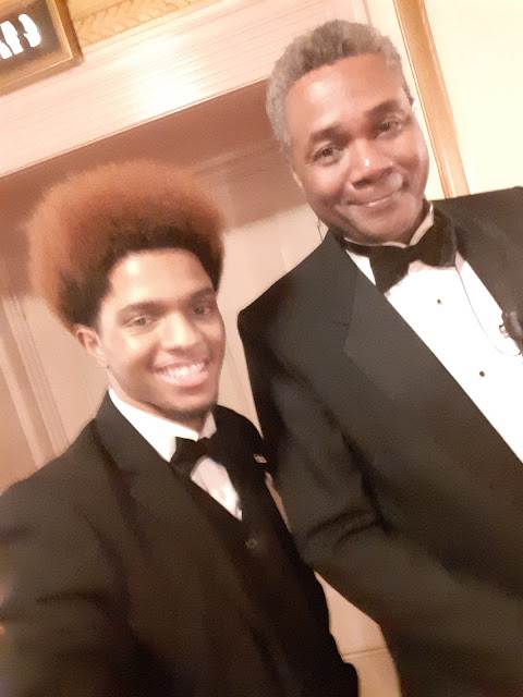 A Colleague of A Drood Chairman: 2019 Selfie Photo of a pleased Lyric Opera of Chicago Guest Services Associate with stage actor and play director Darryl Maximilian Robinson by Torrence.