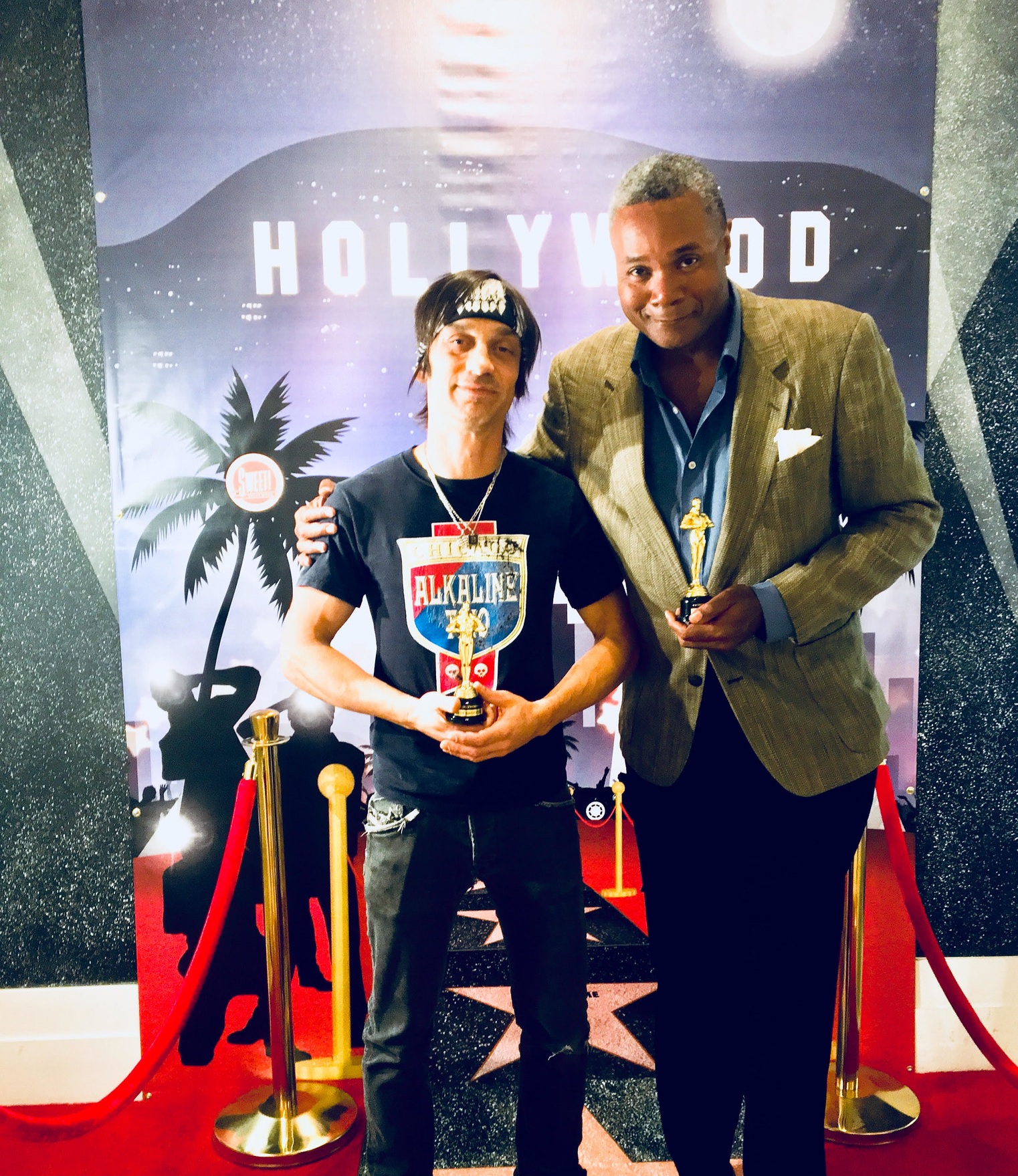 Stage Actors Have Screen Dreams, Too: Excaliber Shakespeare Company Los Angeles Archival Project Members Danny Belrose and Darryl Maximilian Robinson jokingly pose with Fake Oscars in Hollywood.