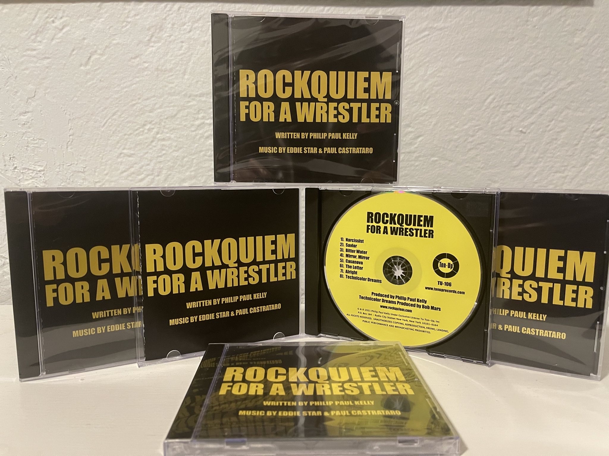 Ton-Up, Inc. is proud to announce the release of a live cast recording from the Rock-n-Roll Wrestling Spectacle, “Rockquiem For A Wrestler.” *The CD of a Live Cast Recording containing eight songs from the show, recorded at New York’s Triad Theater on June 27, 2020, was released on January 7, 2022.