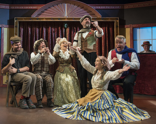 The cast of Christmas at the Old Bull and Bush in the Cratchit family scene. A British Music Hall entertainment with song and dance, silly jokes and sentimental favorites and, of course, Christmas crackers.