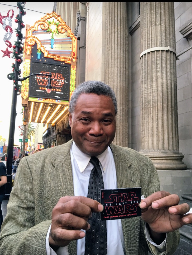 A Lovely Day Gig Benefit: Excaliber Shakespeare Company Los Angeles Archival Project Founder Darryl Maximilian Robinson happily displays a pair of Employee Comp Tickets to see The Last Jedi. 
