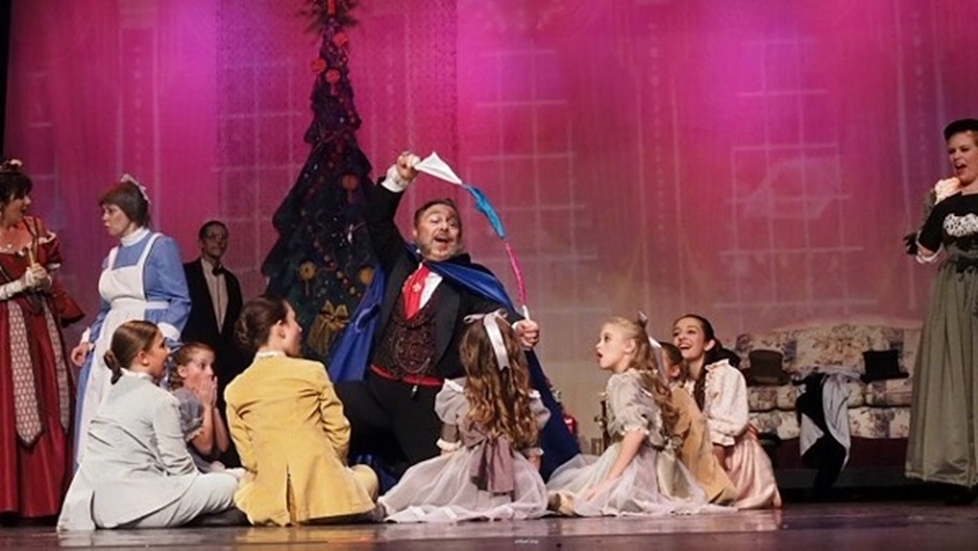 Edward R. Cox as Uncle Drosselmayer performs magic to entertain the Party Children. Edward R. Cox as Uncle Drosselmayer performs magic to entertain the Party Children.