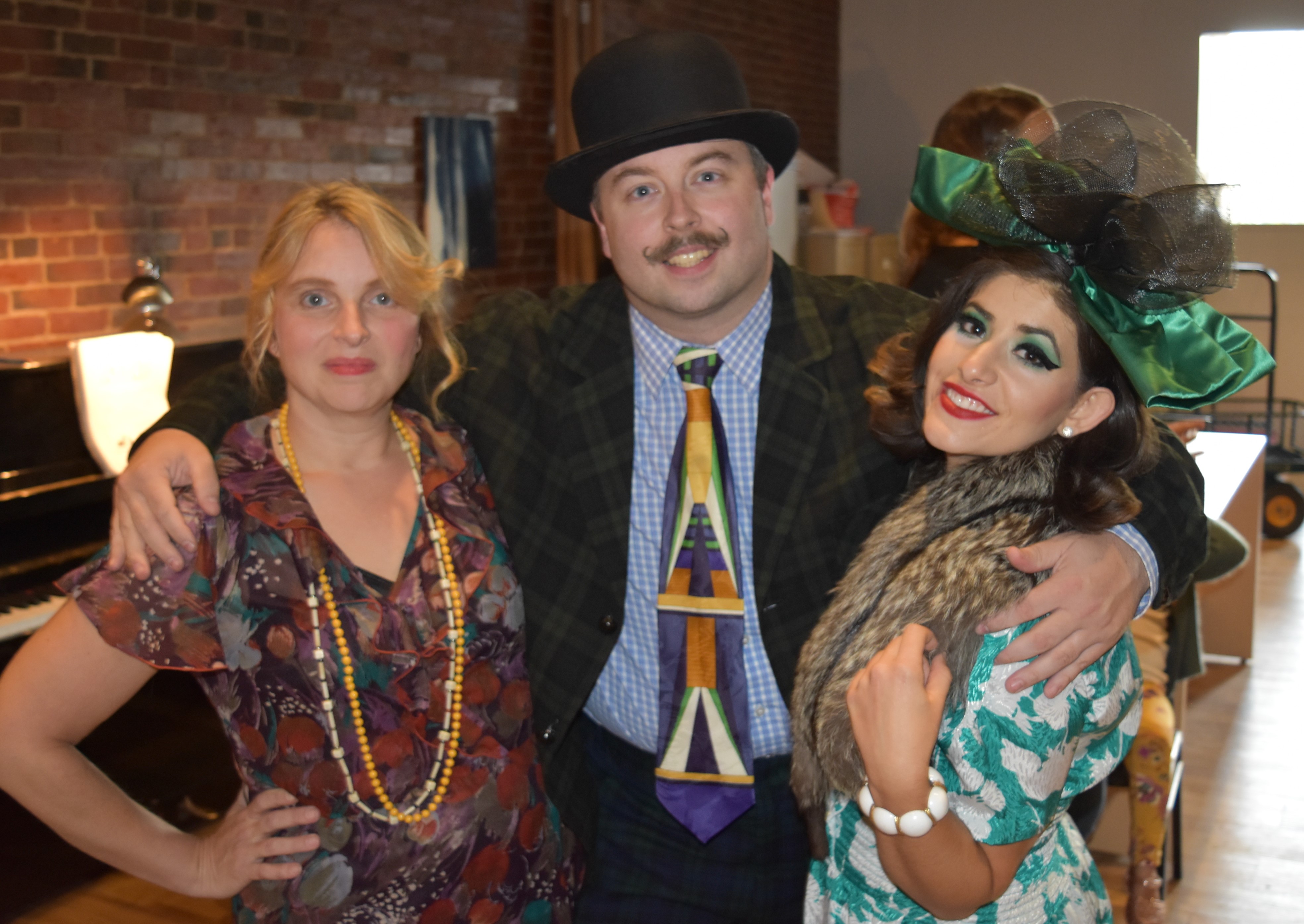 Cast members from the upcoming Community Little Theatre production of 'ANNIE' gave a musical sneak preview of the show recently at the L-A Art Walk in downtown Lewiston. Pictured left to right are Renee Mahon Davis (Hannigan), Chris Dostie (Rooster), and Rachel Campoli (Lilly), who performed 