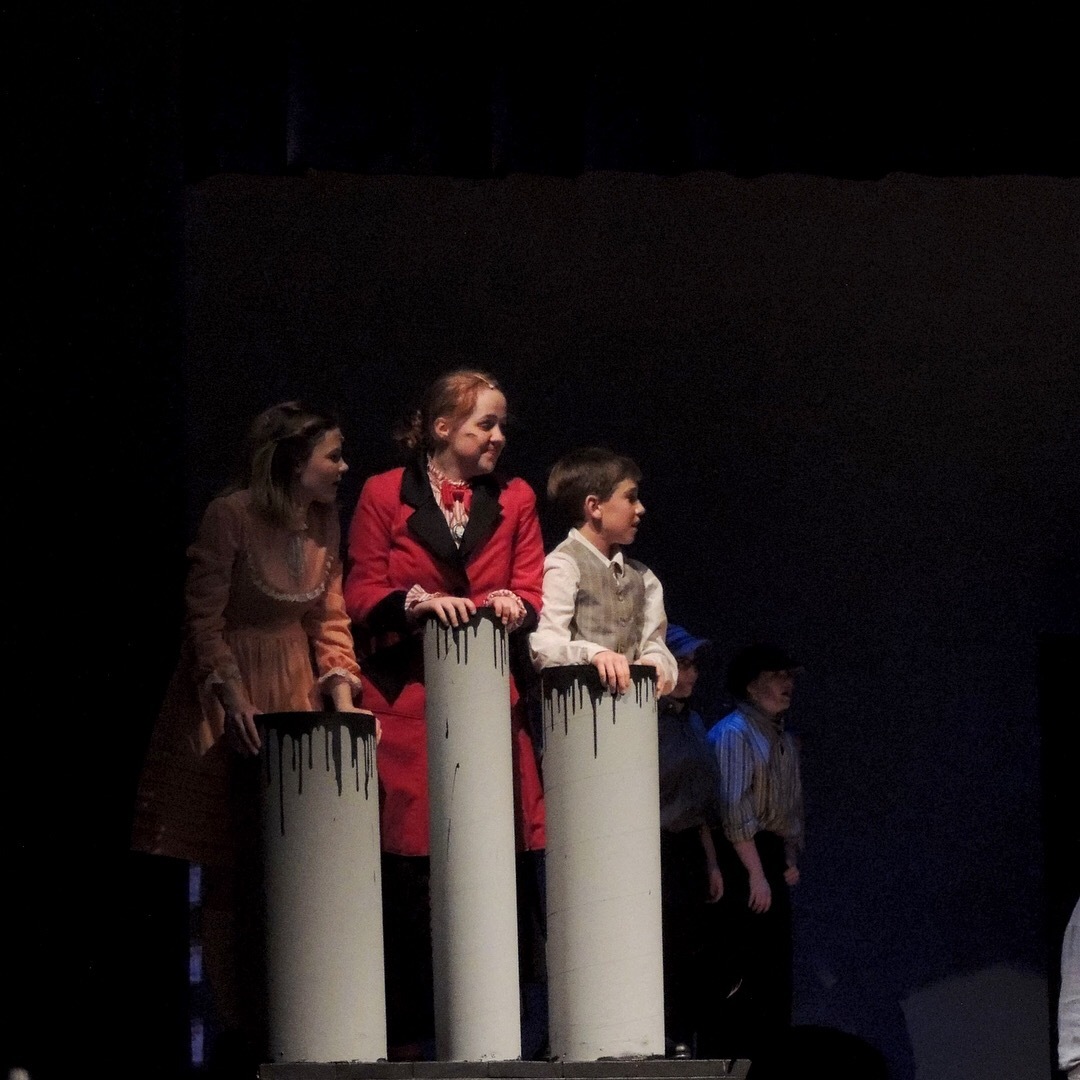 Bert (Michael Florio), Mary Poppins (Christina McBride), Jane (Lindsey Mousch), and Michael (Christopher Miller) at the gates of the park before 