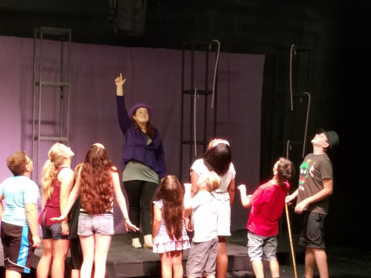 Maggie Toner as Willy Wonka leads the Golden Ticket Winners into his famous chocolate factory.