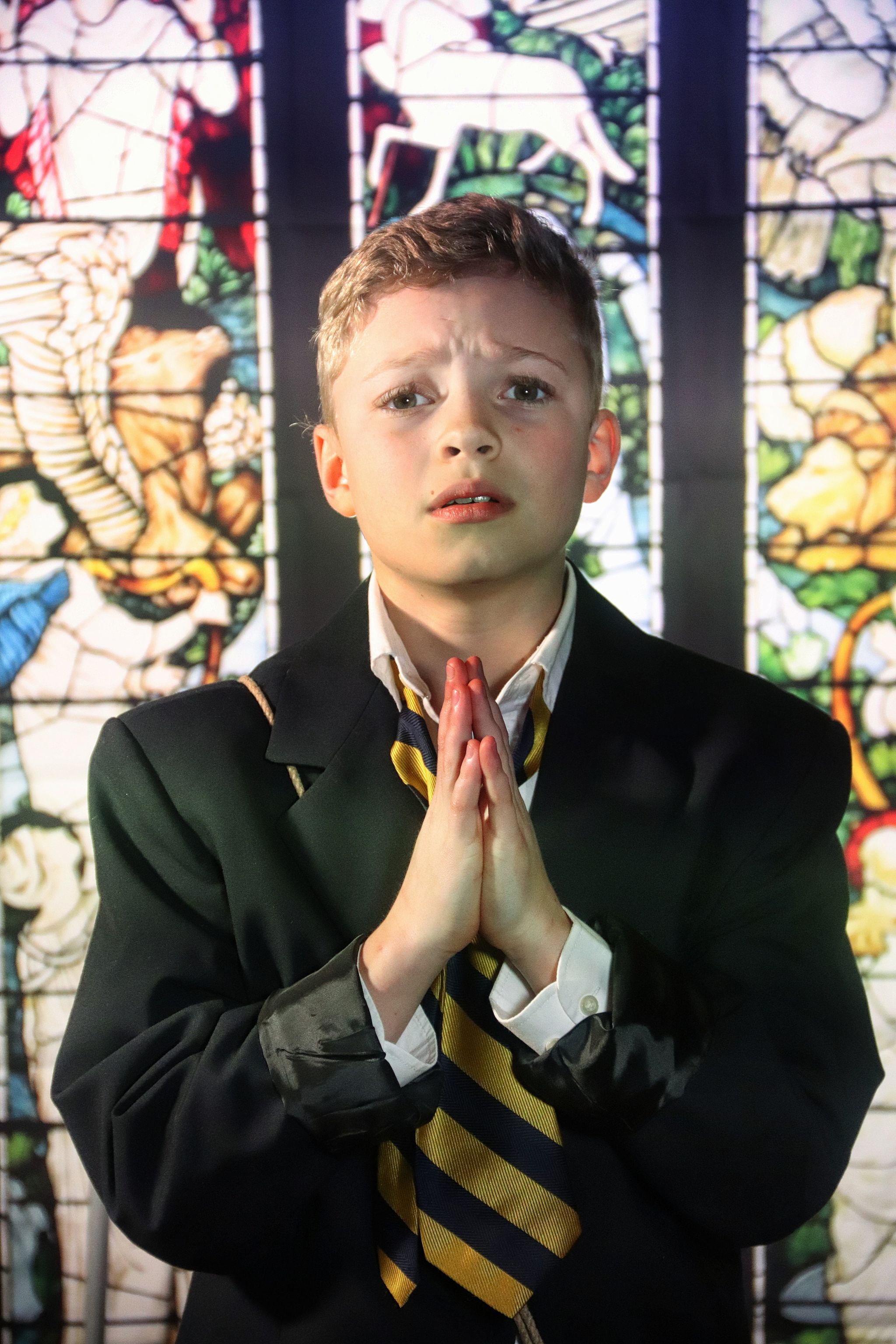 Tommy Murphy (Jack Wolf) praying that his dad bring home Fish and Chips and Mushy Peas.
Photo Credit: Kate Murray Studios