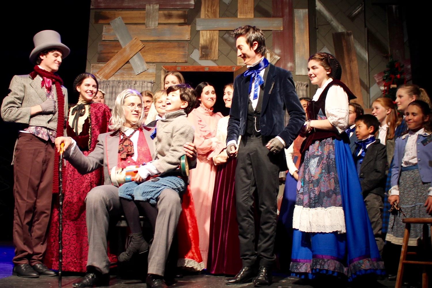 Quinn Robinson as Scrooge and the cast of 