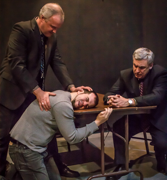 Ariel (John Ade) l and Tupolski (Scott Nangle) interrogate the writer, Katurian (Tom Mazzarella) in a scene from The Pillowman. 2