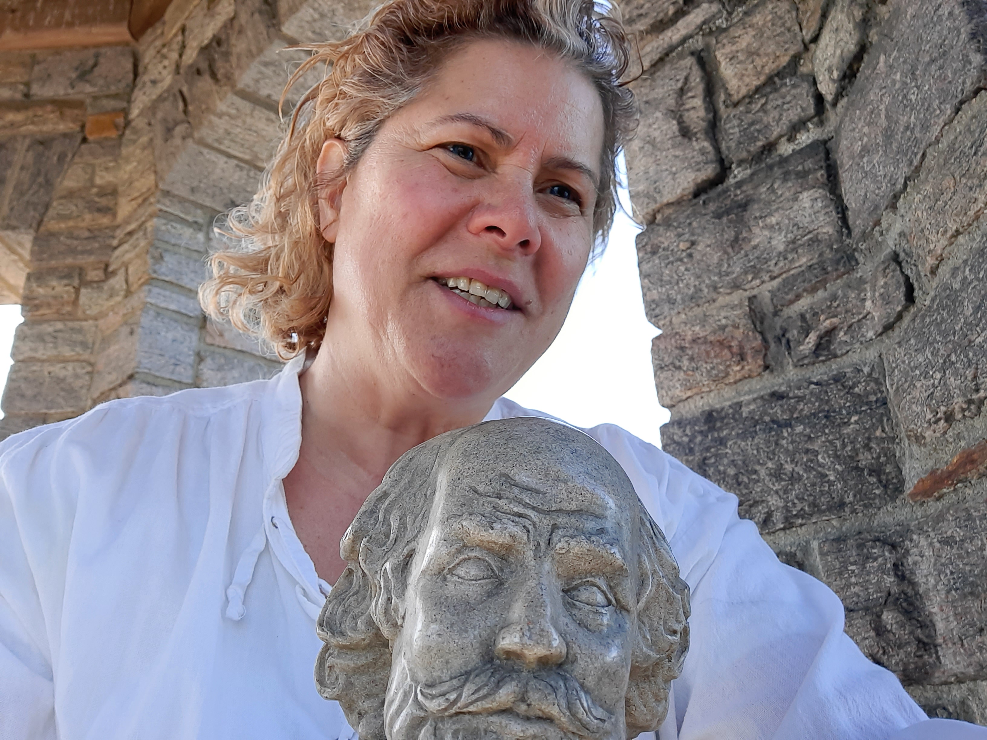 Narrator Maryann Penzero poses with a bust of Shakespeare during filming. (photo credit: MaryAnn Penzero)