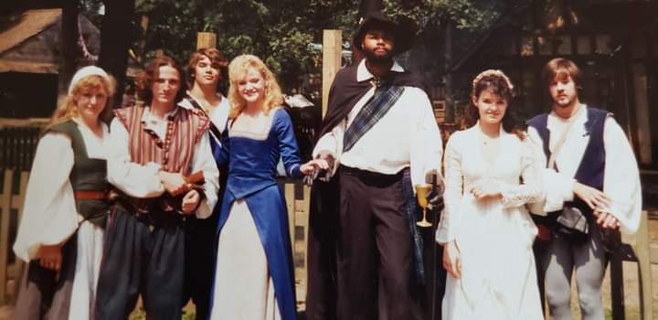 Seen here with lovely and talented young actress Amy Ladley as Lady Lillith ( being escorted at center-left, who did fine Improv scene work and gave a strong dramatic reading of The Bard's Sonnets towards the end of each and every faire day ) and the invaluable comedic faire actor Tony Hrubes ( at far right ) along with other loyal, committed and capable performers who poured their hearts into performing and serving as The Shakespearean Players of Bristol, Your Humble Servant In The Theatre, Darryl Maximilian Robinson ( at center ), playing His Most Revered Lordship, Sir Richard Drury Kemp-Kean ( Shakespearean actor and time-traveler ) had one of the highlights of his career working with these talented folks who brought The Immortal Bard's scenes and words to life at the 1989 Bristol Renaissance Faire, where as Director and Instructor of Shakespearean Theatre for The Bristol Theatre Academy he had the privilege and pleasure of supervising their often wonderful work.
Darryl Maximilian Robinson is grateful and blessed to have worked with these fine artists and human beings during his summers at The Bristol Renaissance Faire and remembers them all with affection.
