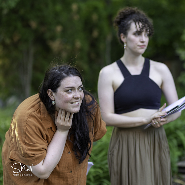 Margaret (Mallory K. Lewis, L) and Ursula (Julia Siegal) watch the sparks fly.