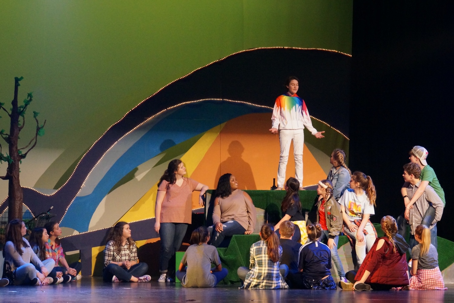 Jesus sharing a story with the ensemble. This version of Godspell, Jr. had a groovy-kind of Memphis, TN feel with the bridge and pyramid in the background 1