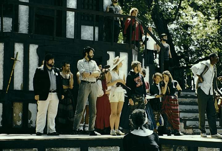 WHODUNIT?: Enjoying one of the best comedic roles of his early career on an outdoor Renaissance Festival Mainstage, future Excaliber Shakespeare Company of Chicago and Excaliber Shakespeare Company Los Angeles Archival Project Founder Darryl Maximilian Robinson ( seen on the far right amongst the group of performers of The Court ) rehearses his Royal Court Member Role as His Eminence, Tomas de Torquemada, The Grand Inquisitor of Spain ( who is ultimately both a detective and a suspect ) in 