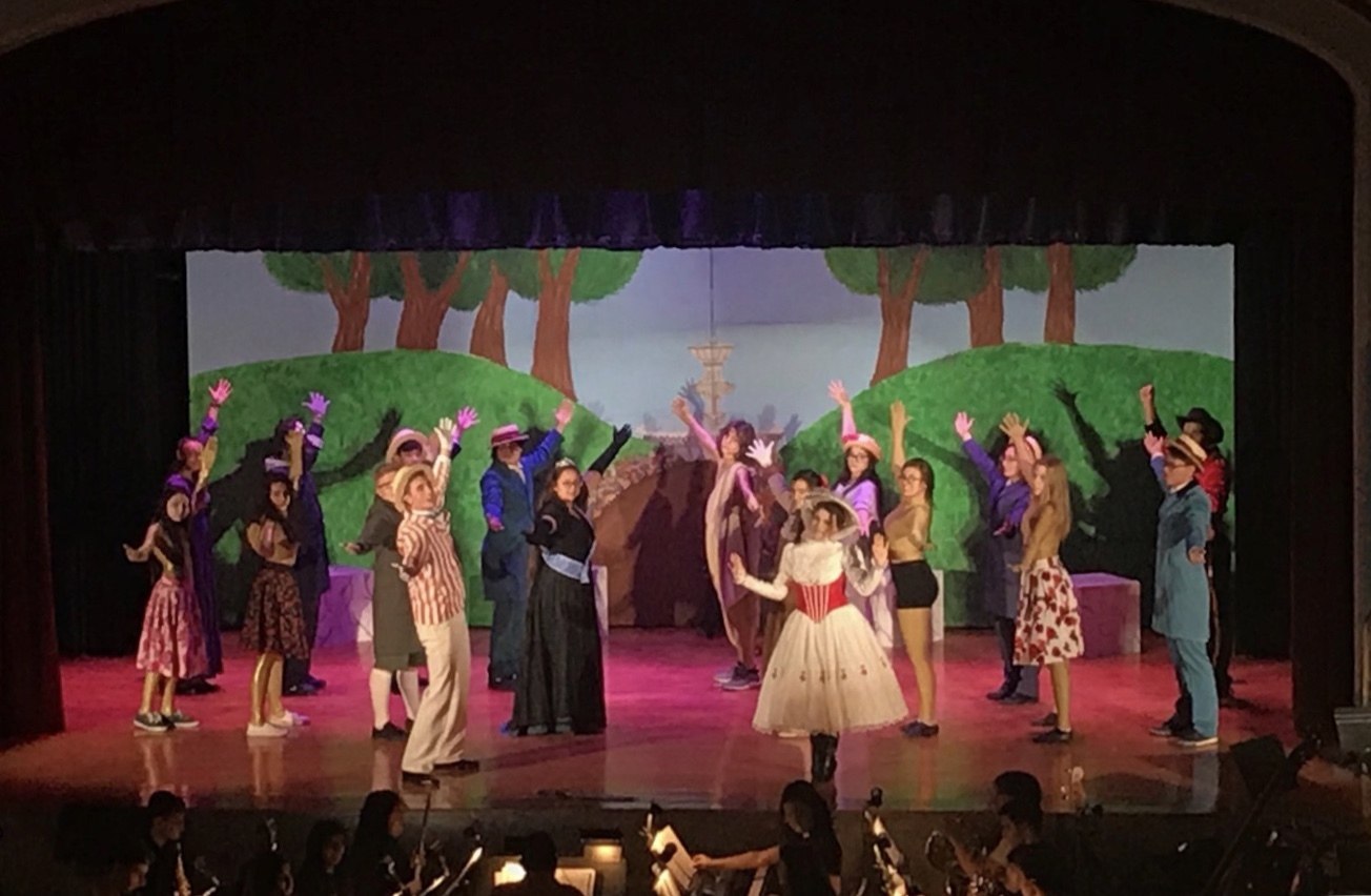 Cast rehearsing a dance and song number 