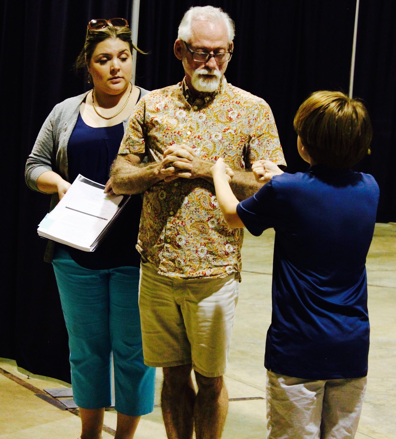 Director Richard Justice works with Amy Patton (Mrs. Corney) and Owen Johnston (Oliver Twist) 