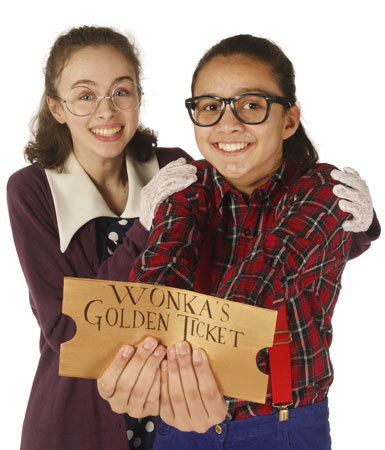 Two smiling children hold up Willy Wonka's Golden Ticket. 1