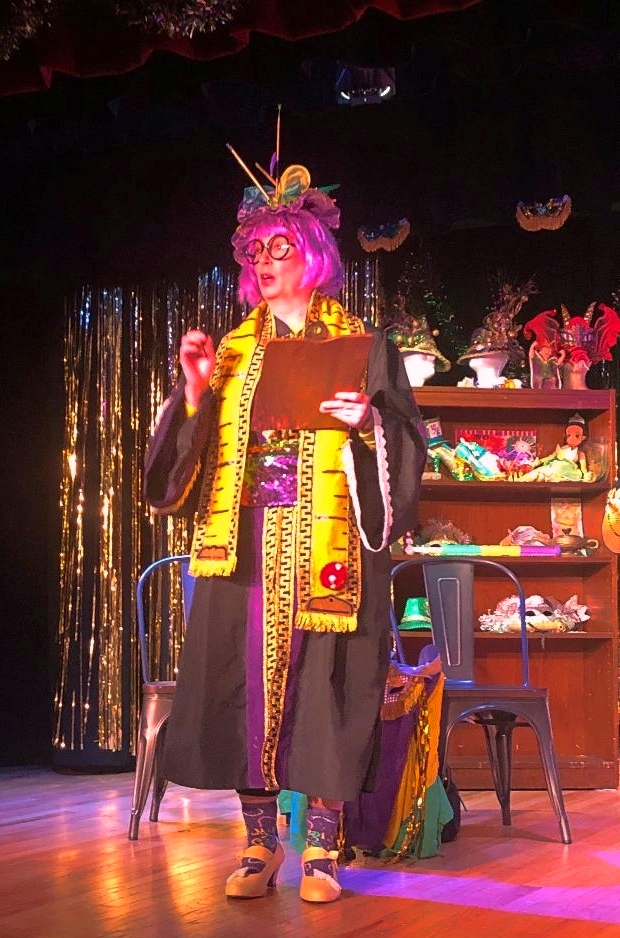 Professor Liuzza, head of Costuming, prepares the audience for the Carnival Bal Masque Couture her students have created this past semester.