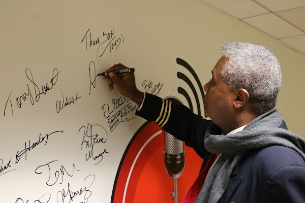 SIGNING THE UBNGO STUDIO WALL!: After his fourth appearance on Ron Brewington's 'The Actor's Choice', veteran and award-winning stage actor and play director Darryl Maximilian Robinson was invited to sign the studio's logo wall. Photo by J.L. Watt.