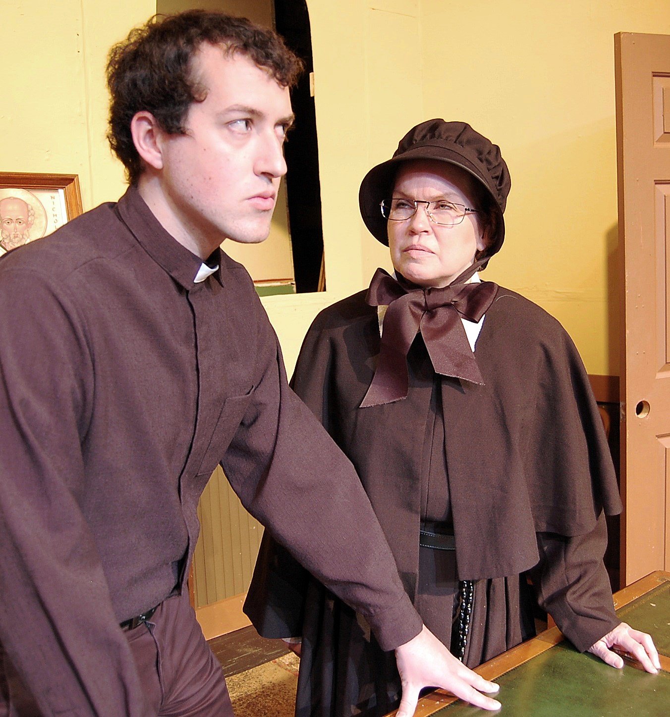 The stern Sister Aloysius (Joyce McGookey of Royal Oak pictured R) questions the young nun; Sister James (Erica Shubin of Ypsilanti) (L) in Doubt, a Parable.
3