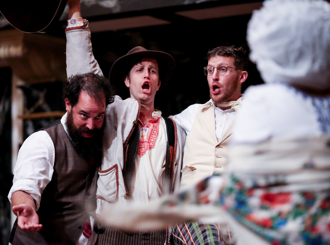 Sir Toby Belch (David Anthony Lawson), Feste (Chris Johnston), and Sir Andrew Aguecheek (Patrick Earl) sing and celebrate.