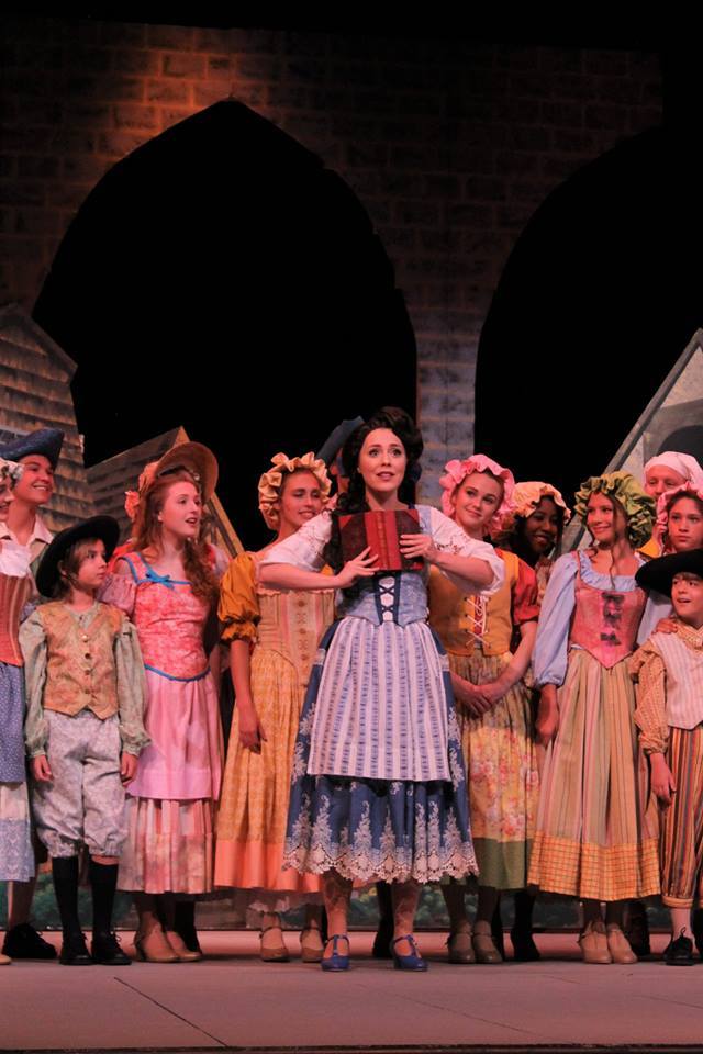 Belle with the townspeople of the village. 1