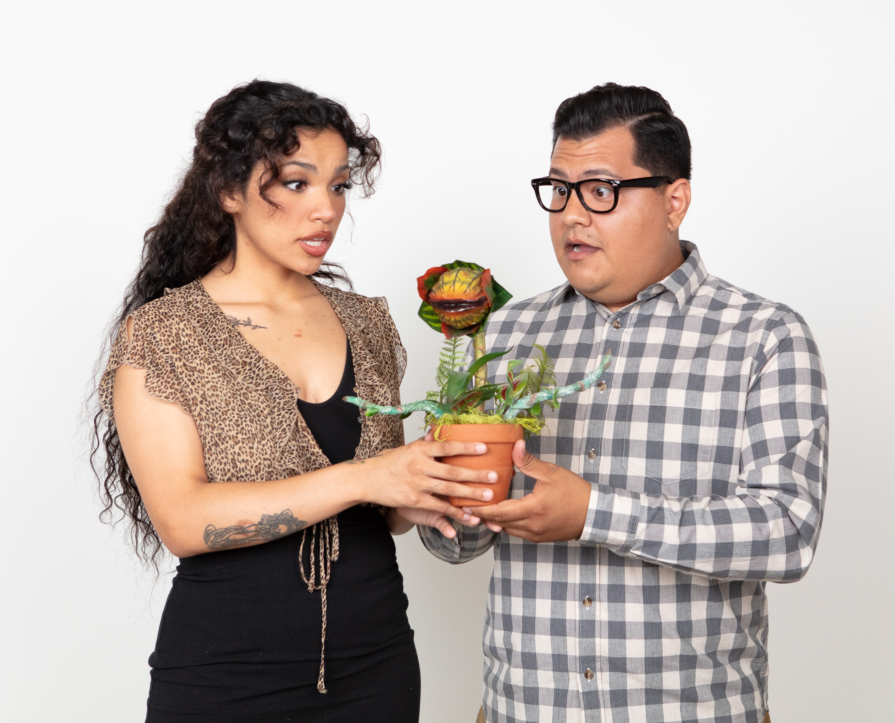 Photo of Seymour and Audrey with the plant (Ramiro Garcia Jr. and Lena Ceja). Photo by Mark Holmes.