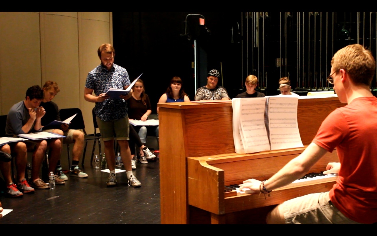 Connor Stout (Roger) rehearses with Music Director, Tom Bonezzi at the Medina Performing Arts Center for the July production of RENT.