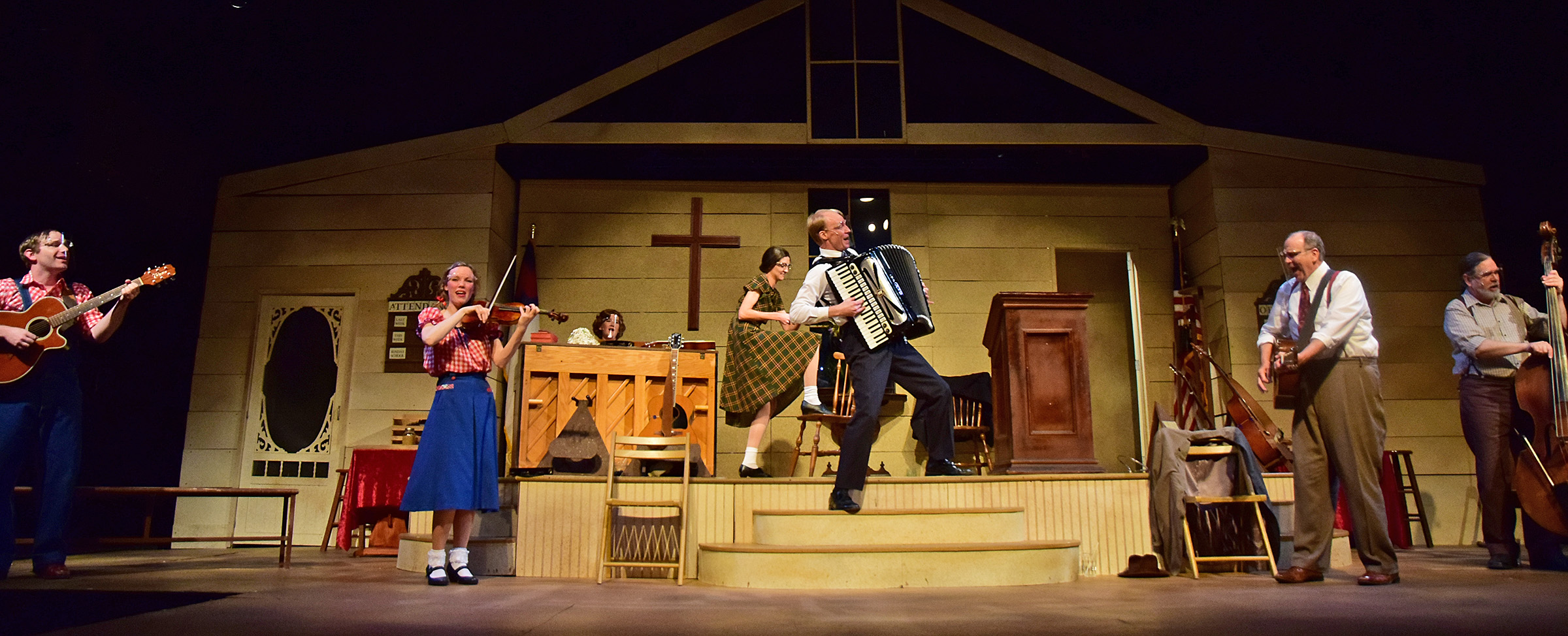 The Rev. Oglethorpe (A.J. Morrison), center, grabs his accordion to play along as the Singing Sanders Family performs 