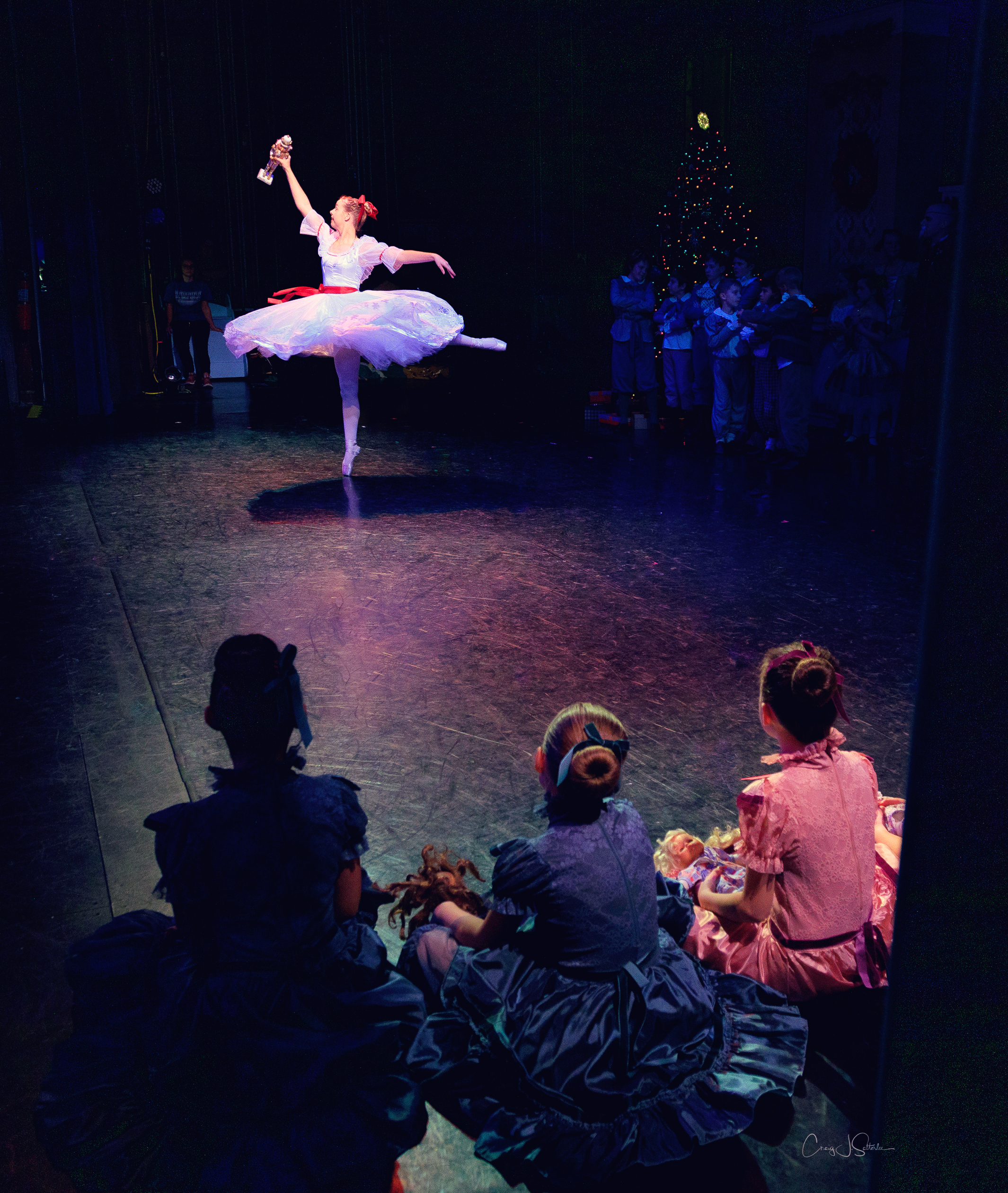 Clara dancing with her Nutcracker while Party Children look on