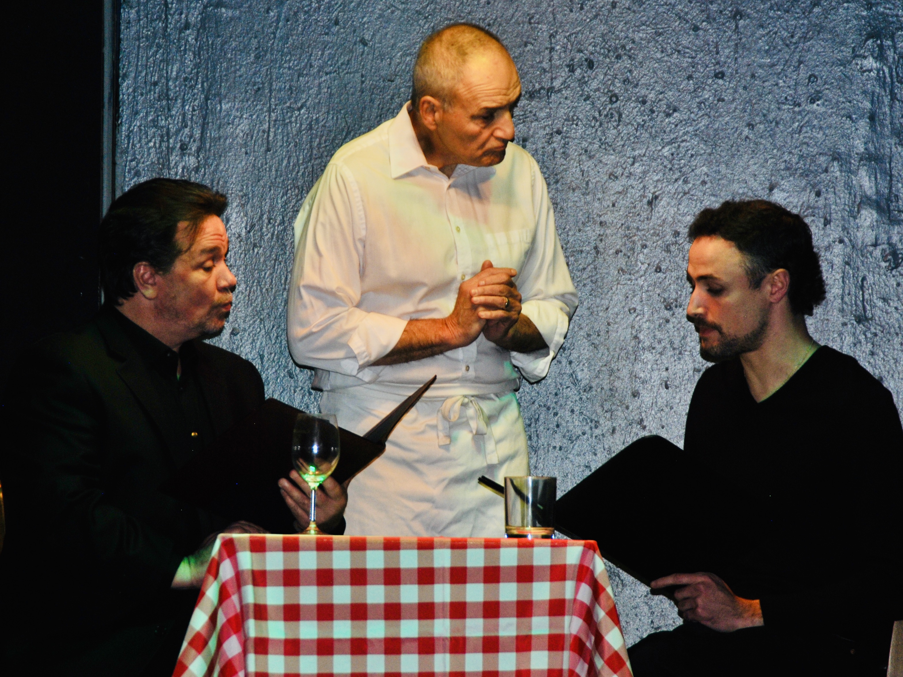 Robert (John Griffin) has lunch with best friend Jerry (Anthony Casiano), attended by waiter (Tony Verrilli)