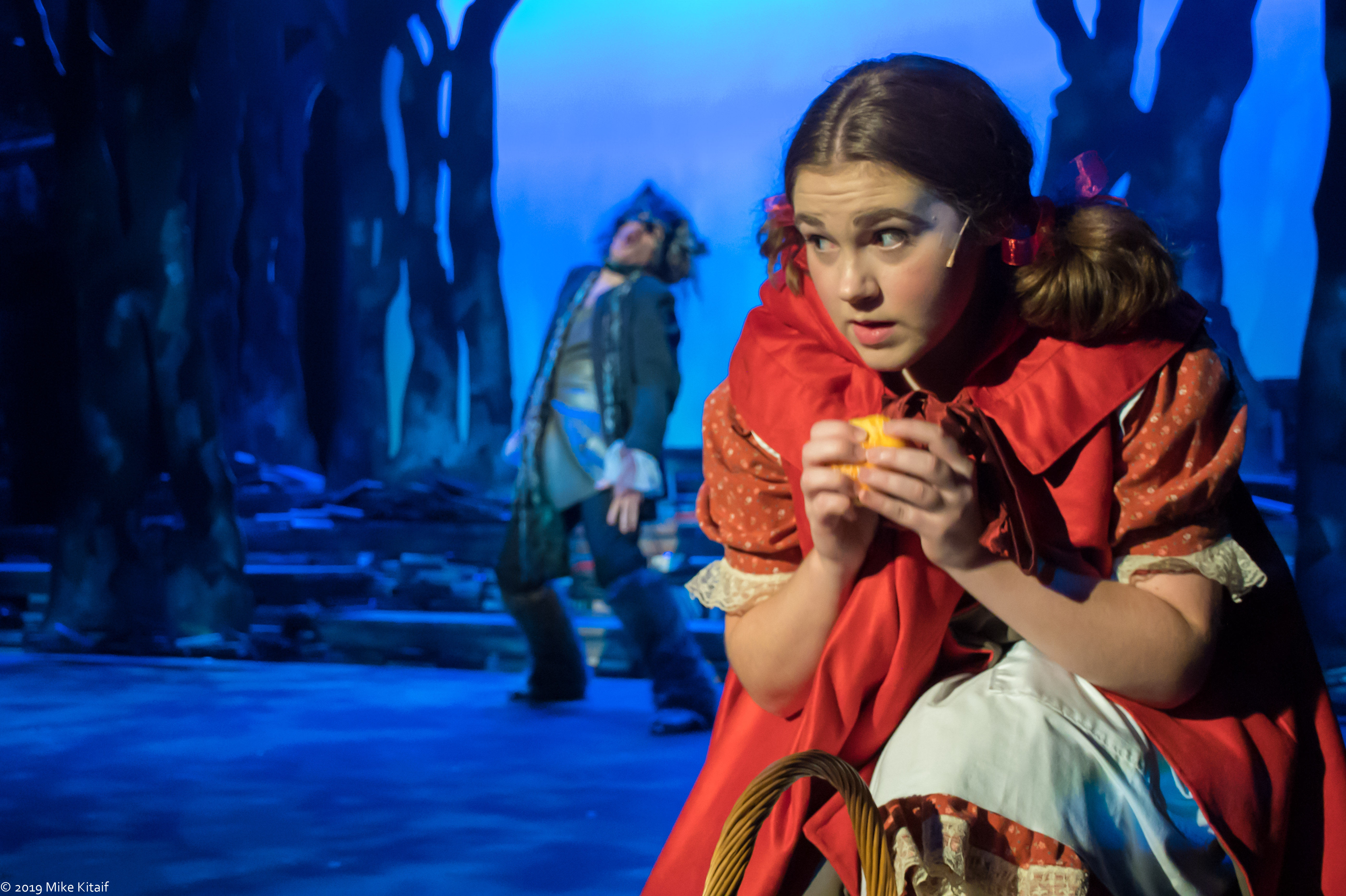 Little Red Riding Hood (Hayley Sanz) is on her way to her grandmothers house when she encounters a wolf (Andrew Johnson).
