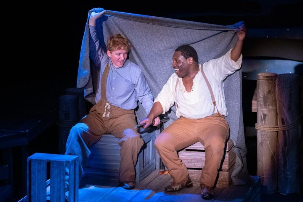 Jim (Khawon Porter) and Huck (Christopher Inhulsen) heading down the Mississippi in Big River at Temple Theatre