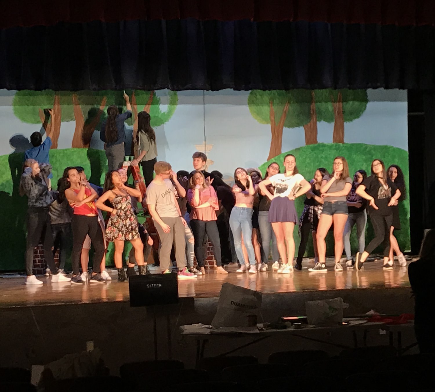 Cast rehearsing a song and dance