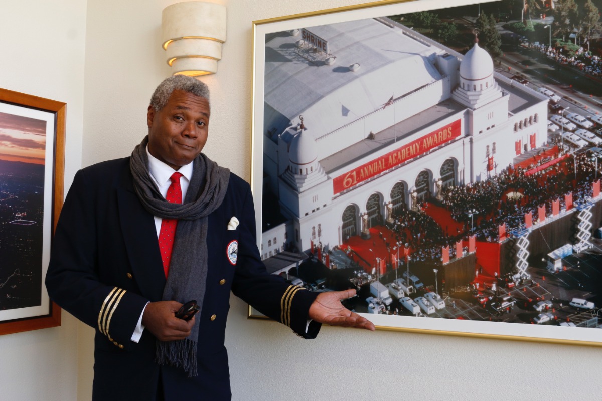 A MOST INTRIGUING PORTRAIT!: Darryl Maximilian Robinson admires the 61st annual Oscars Ceremony photograph at UBNGO studios in Burbank CA prior to making his April 18, 2022 fourth appearance as A Guest Actor on Ron Brewington's internet performing arts television show 'The Actor's Choice' Episode 8.16. Photo by J.L. Watt.
