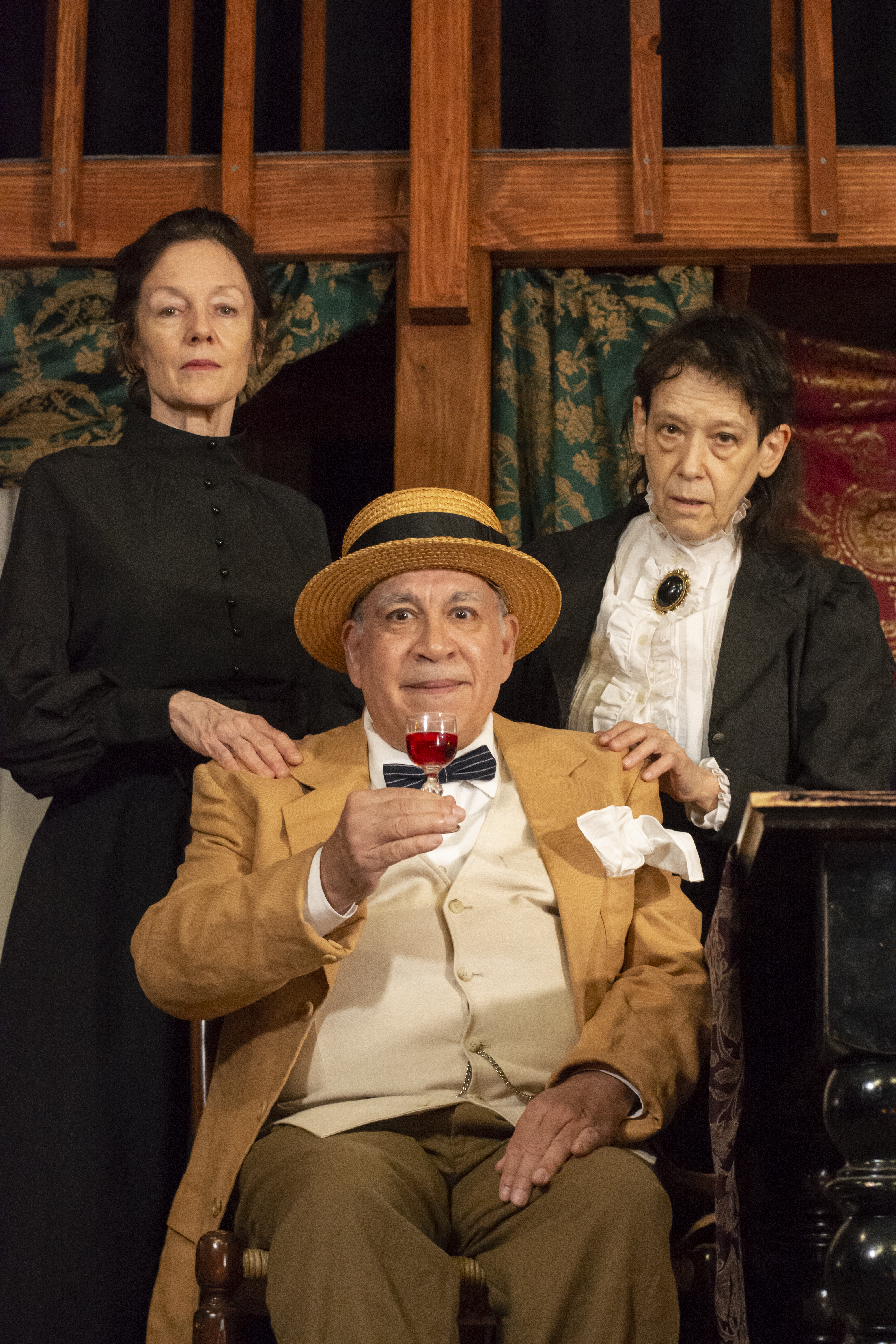 The Brewster Sisters (Margaret Trotter and Judith Shakespeare) offer a guest (Martin Revere) their elderberry wine.