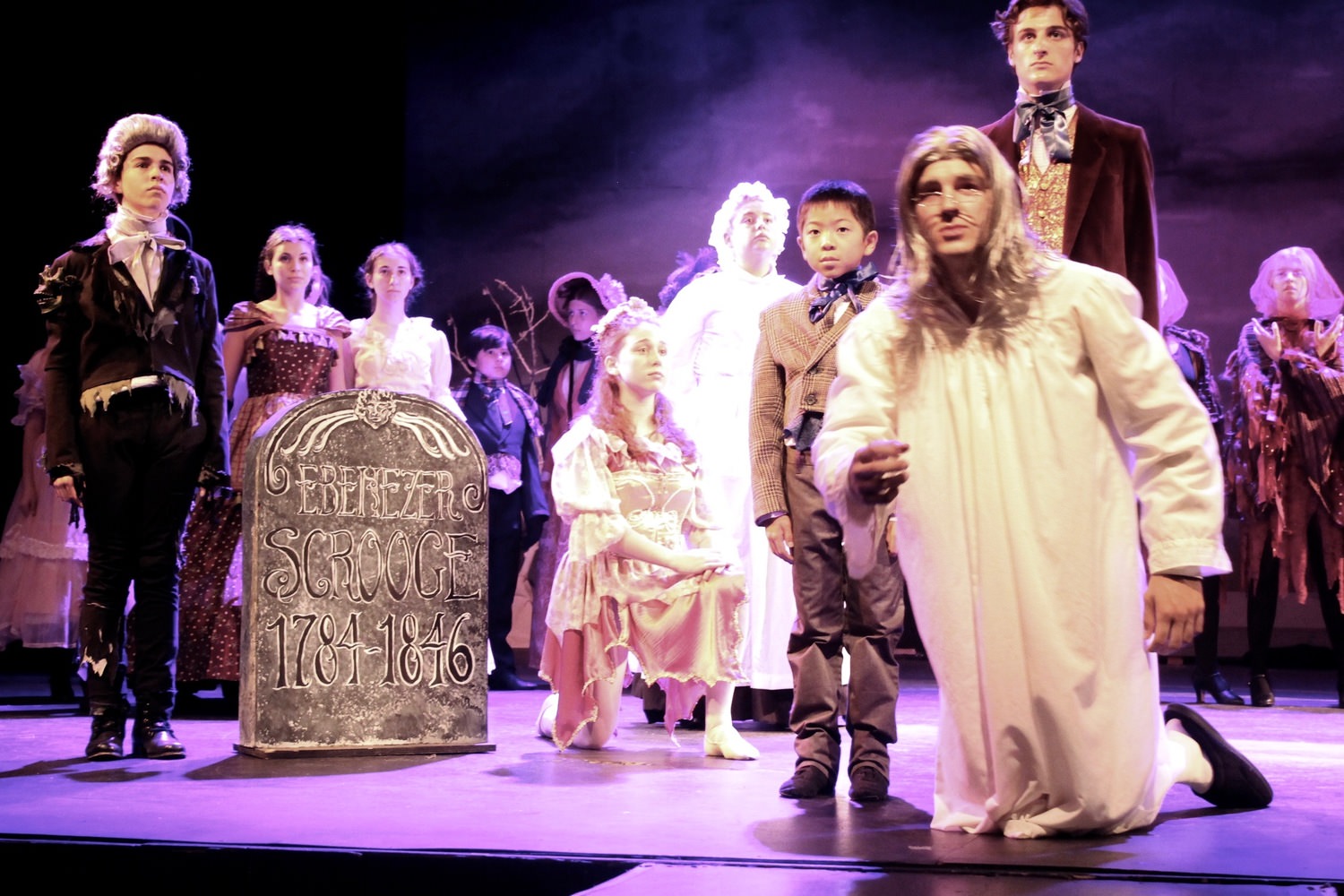 Quinn Robinson as Ebenezer Scrooge and the cast of the Morgan-Wixson Theatre's production of 