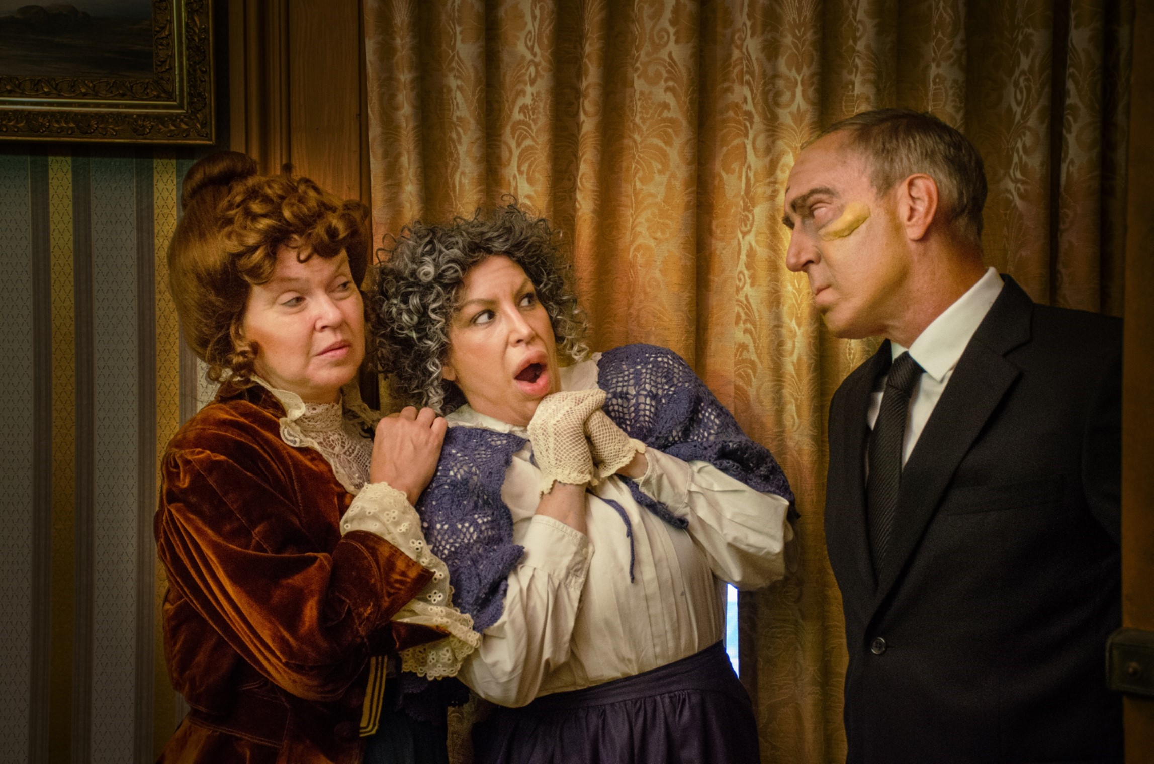 Jonathan (Steve Larson) pays an unwelcoming surprise visit to his Aunts Martha (Joyce McGookey, left) and Abby (Andrea Krass McDonald, right) in Village Player's Production of Arsenic and Old Lace. (Photo credit: Joseph Lease)