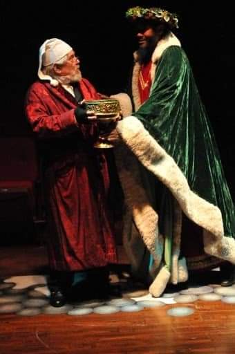 A Good Spirit: Mario Di Gregorio as Ebenezer Scrooge and Darryl Maximilian Robinson as The Ghost of Christmas Present in the 2010 Glendale Centre Theatre of Glendale, California A Christmas Carol.