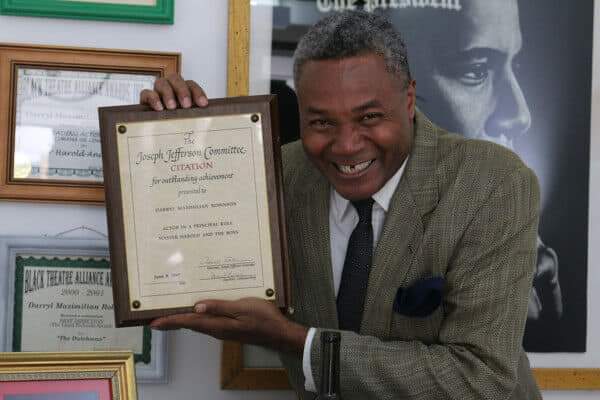 Excaliber Shakespeare Company Founder Darryl Maximilian Robinson proudly displays his 1997 Chicago Joseph Jefferson Citation Award for Outstanding Actor in Master Harold And The Boys.
