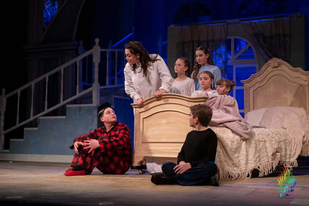 From left to right in front of bed: Jaxson Clendenin, Nate Colton; From left to right on bed: Gabriella Giardina, Blaire DiMisa, Ava Anger, Daisy Tanner, Zeya Swecker